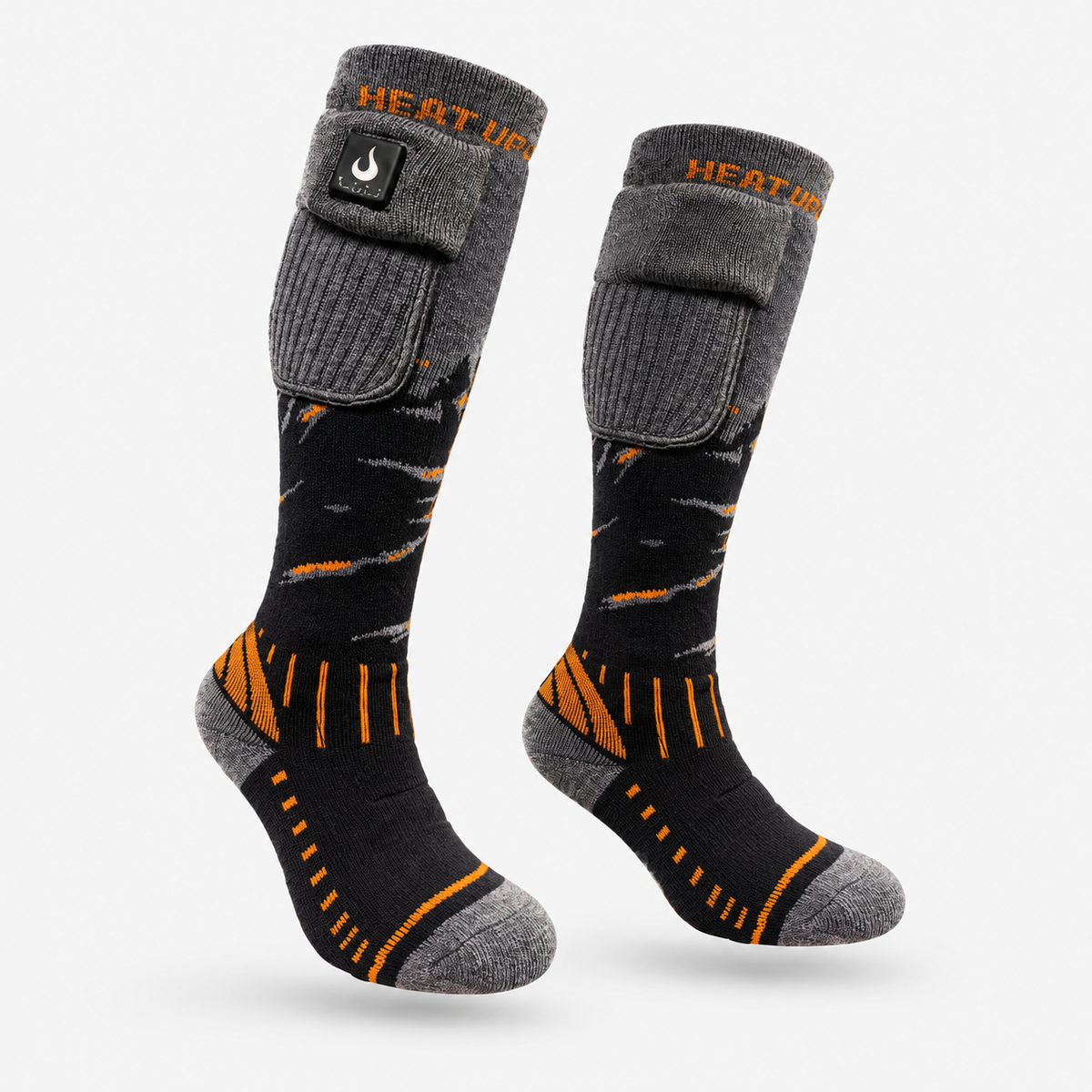 Paire de bas chauffants Junior Heat Up, gris et noir avec accents orange et poche à batterie sur la tige, sur fond blanc