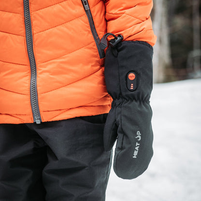Person wearing an orange jacket and black heated gloves in a snowy setting