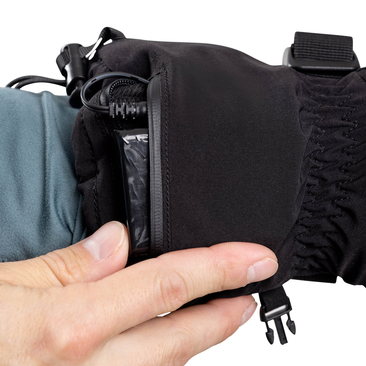 Opening the zippered battery pocket on the cuff of a Heat Up Peak heated glove