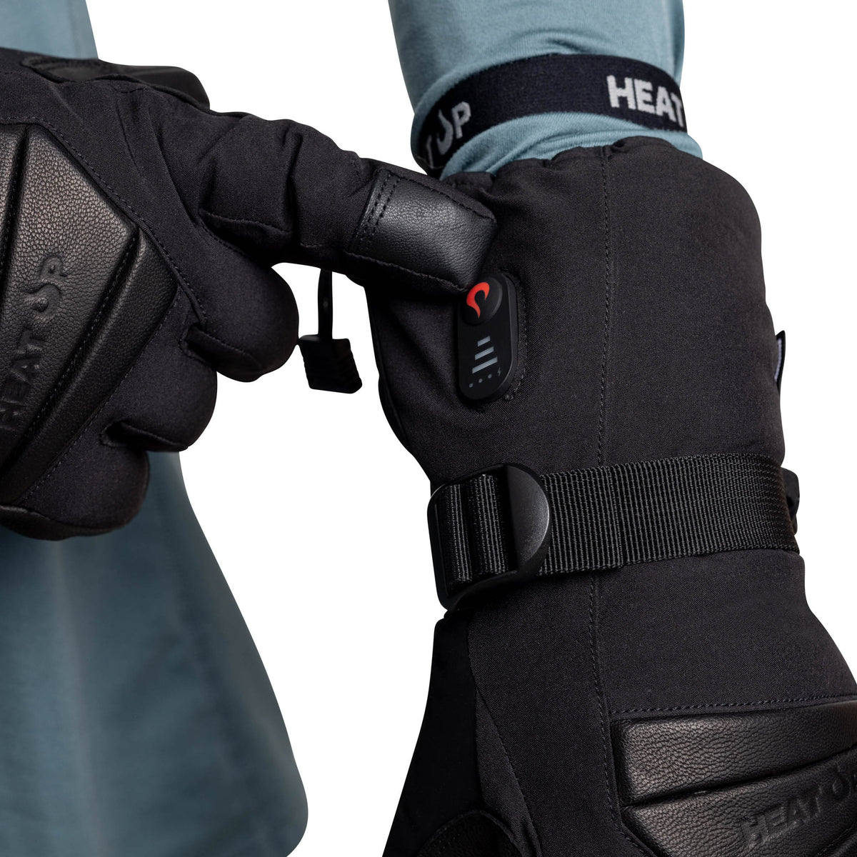Pressing the heat level button on a Heat Up Peak heated glove