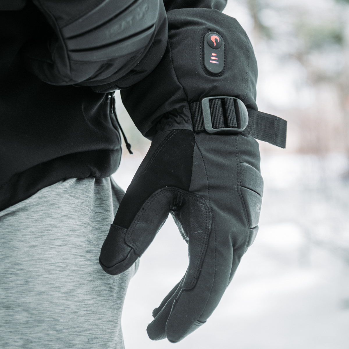 Heat Up Peak heated glove worn outdoors, cuff strap and power LED visible